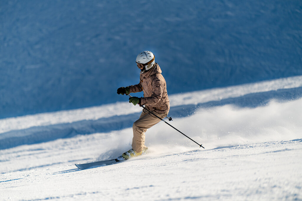 Female skier skiing down the slope