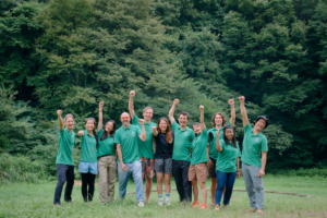 People with green shirts raising their fist into the air