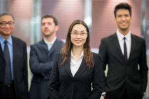 businesswoman surrounded by male coworkers