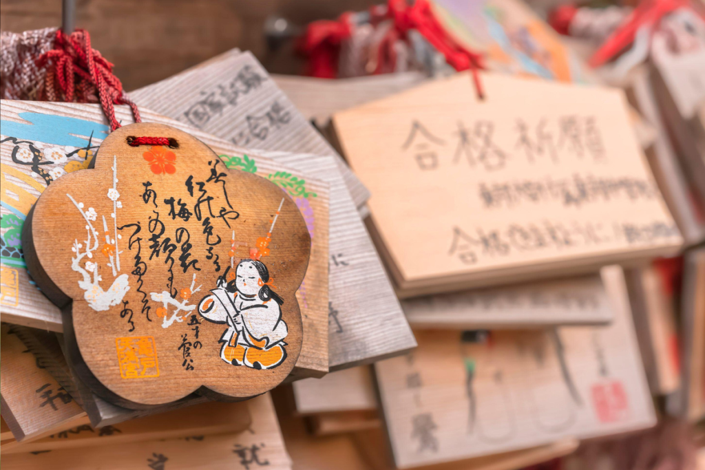 Ema wooden traditional panels with Japanese script hanging at a shrine