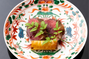 A dashi sauce made from duck bones is poured over duck.