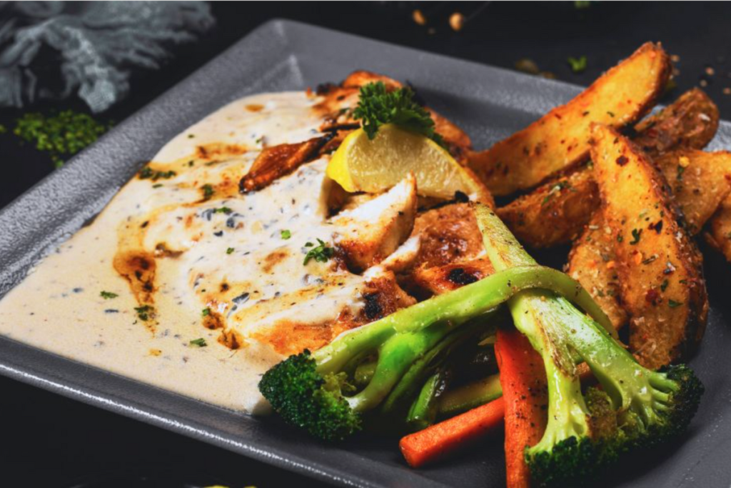 meat with sauce, potato wedges and broccoli