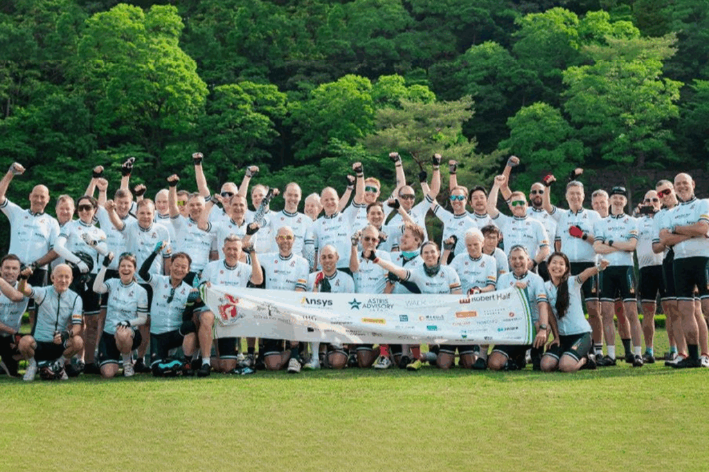 The Knights In White Lycra (KIWL) and KIWL founder at the end of their cycling tour honouring their prestigious award