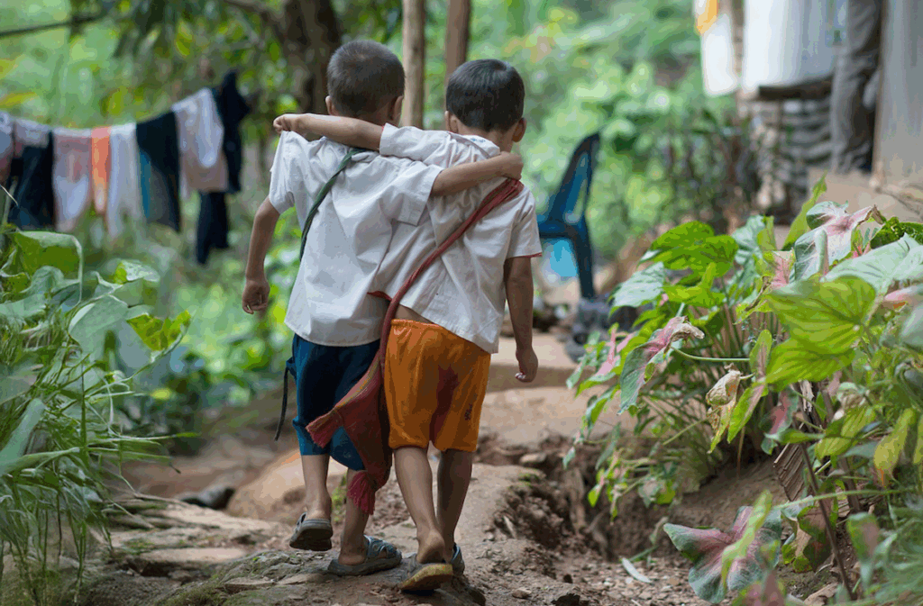 Two children walking together—a reminder of the hope that events like the Cup of Humanity Tea Ceremony seek to honor by supporting displaced families and preserving cultural traditions
