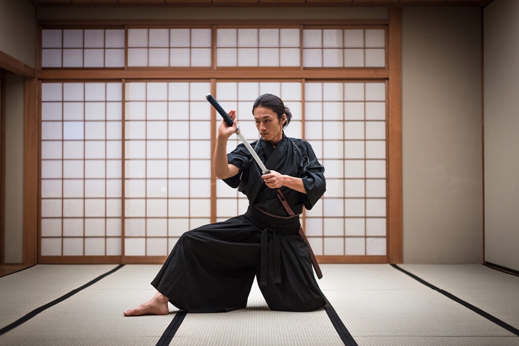 Samurai master wielding a sword, and placing it back in its sheath strapped to his side