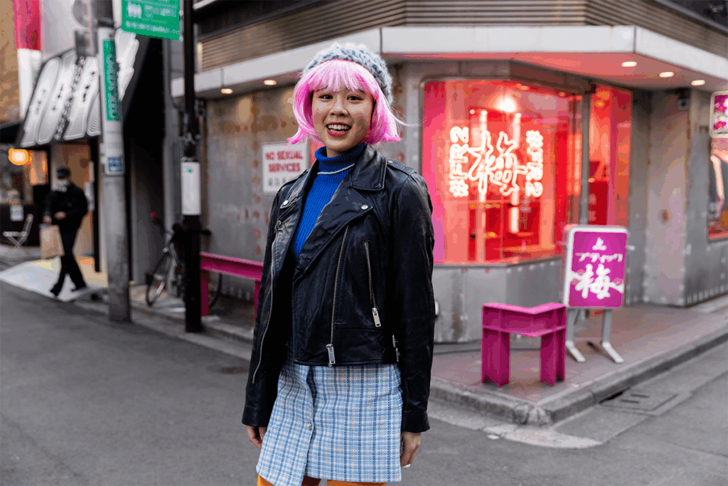 A simplistic Harajuku styled outfit, hot pink wig, beanie, fun patterns, many colors and an edgy leather jacket