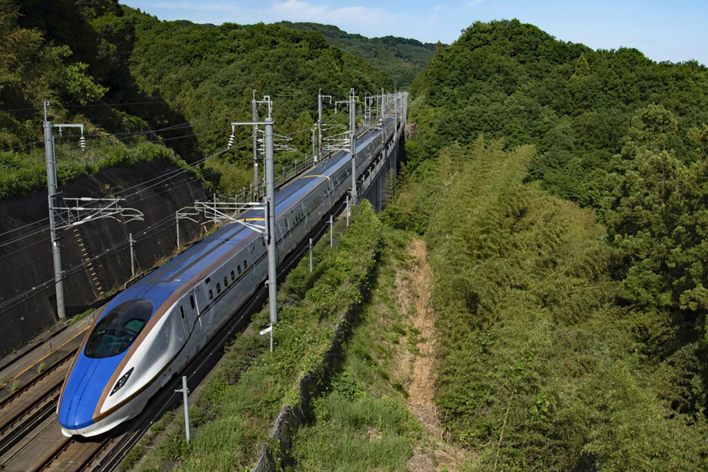 The Hokuriku Shinkansen traveling through the mountains of Japan, runs to and from Takasaki.