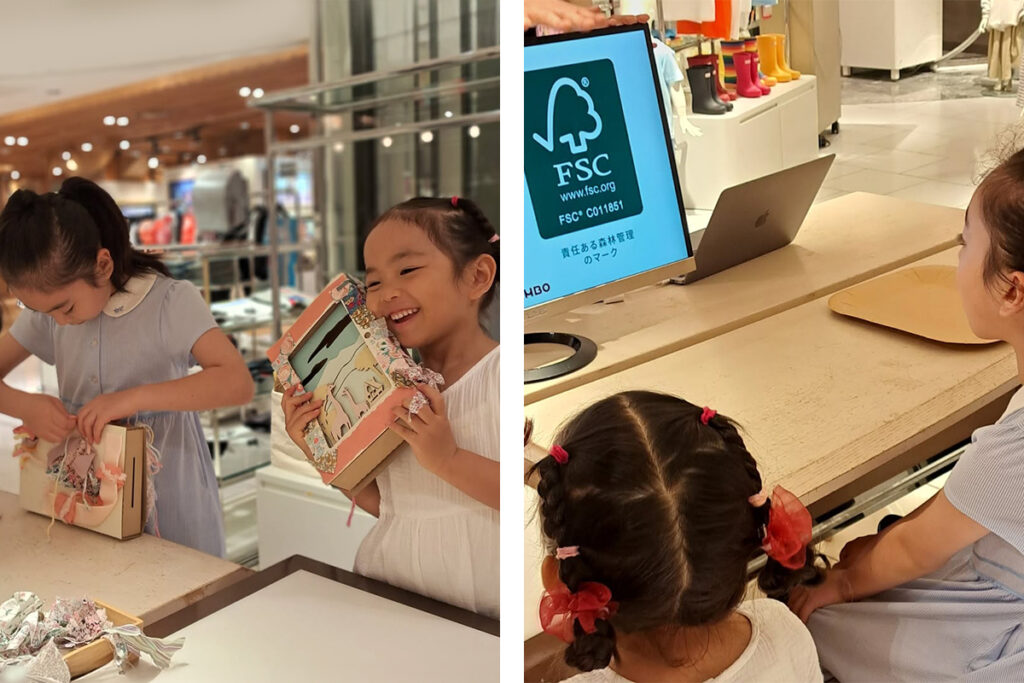 Children at a DAMBO workshop in Isetan Shinjuku learn what FSC trademarks symbolize, and how recycling positively impacts the environment.
