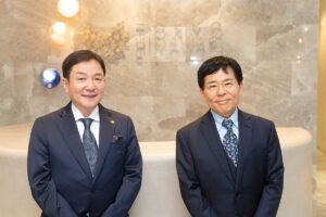 Dr Ryuta Ono and Dr Tsuyoshi Takato standing at the front desk of the clinic