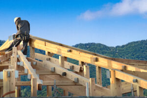 Japanese construction working with mountains in the background