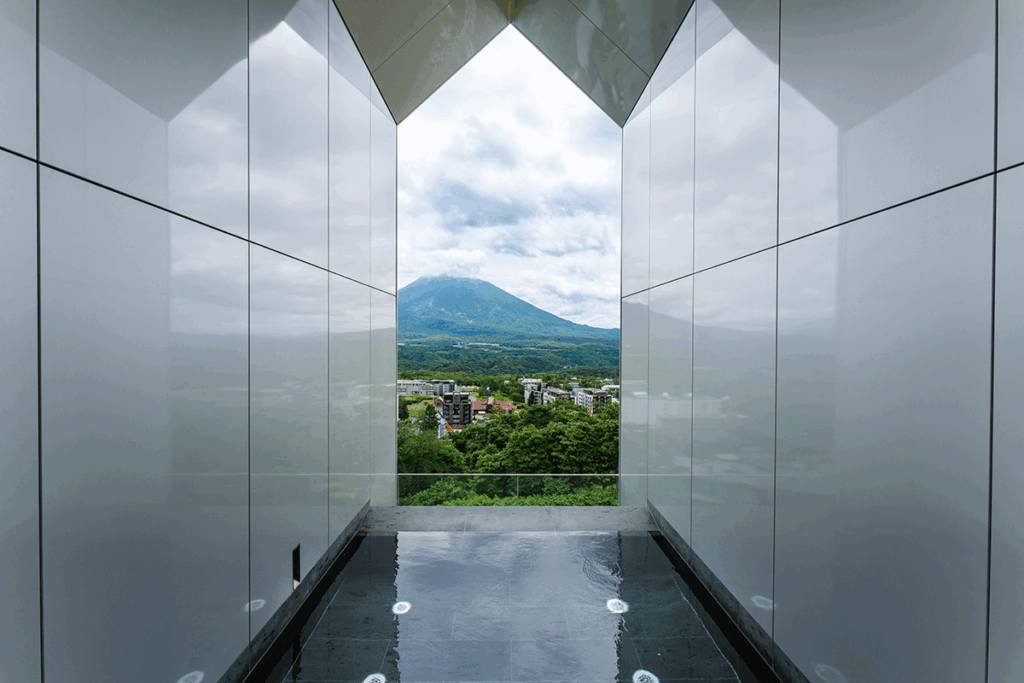 MUWA Niseko's Infinity Onsen, where guests can unwind in soothing waters while taking in uninterrupted views of Mt Yotei, framed like a living painting