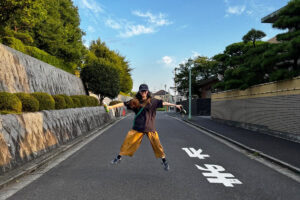 Picturesque Japanese traditional and modern city street with short-stay woman from Hong Kong jumping