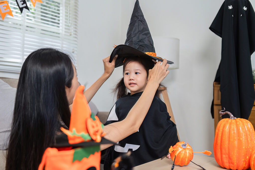 Mother and Daughter Enjoy Halloween Activities Together, Dressing Up in Costumes and Celebrating the Festive Holiday