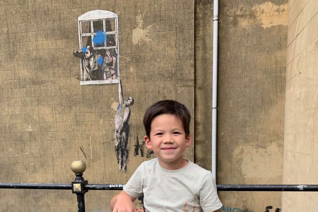 Well Hung Lover, or Naked Man Hanging From Window, by Banksy in Frogmore Street, Bristol.