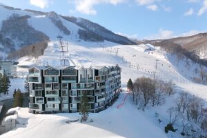 A luxury ski-in ski-out resort at Muwa Niseko surrounded by snowy mountains in Grand Hirafu.