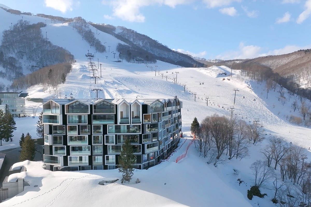A luxury ski-in ski-out resort at Muwa Niseko surrounded by snowy mountains in Grand Hirafu.