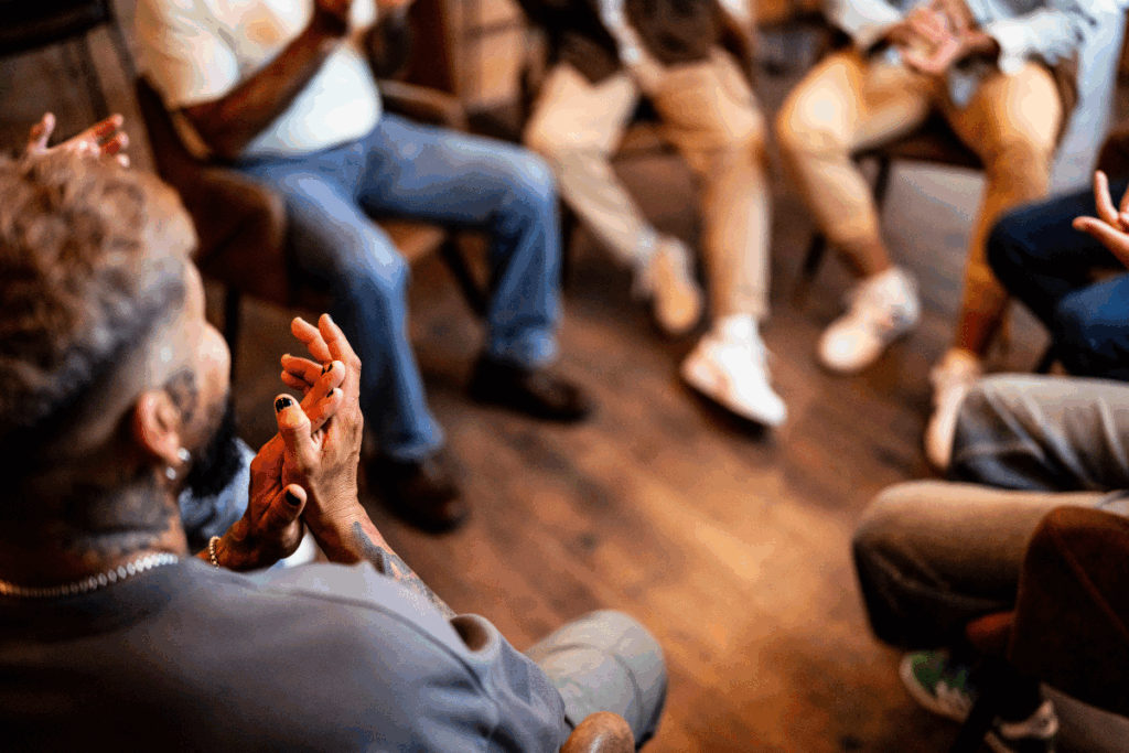 People sitting in a support group sharing experiences, as part of acceptance work.