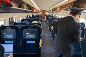 Passengers enjoying a comfortable and quiet ride in the Shinkansen’s Green Car, highlighting its spacious design and refined travel experience.