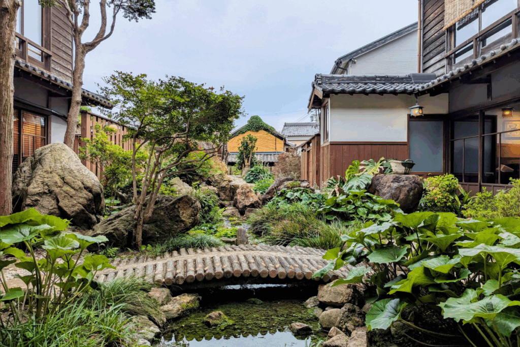 A serene courtyard garden at Kakujoro Ryokan, showcasing traditional Japanese architecture and a peaceful escape in Aichi Prefecture.