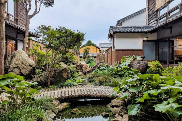 A serene courtyard garden at Kakujoro Ryokan, showcasing traditional Japanese architecture and a peaceful escape in Aichi Prefecture.