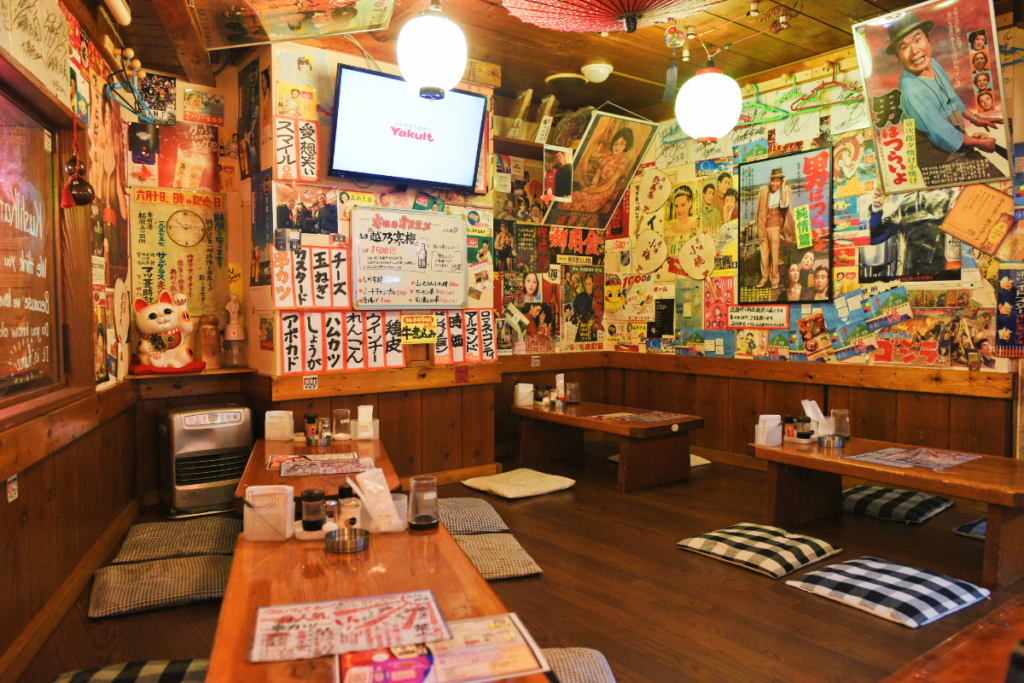 A cozy Japanese café street scene representing the idea of a community third place.
