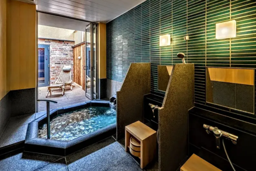 Private indoor hot spring bath with outdoor access for relaxation