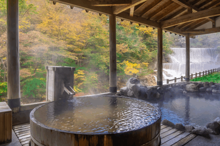 Outdoor onsen overlooking nature during autumn, reflecting the relaxing hot spring retreats near Tokyo.
