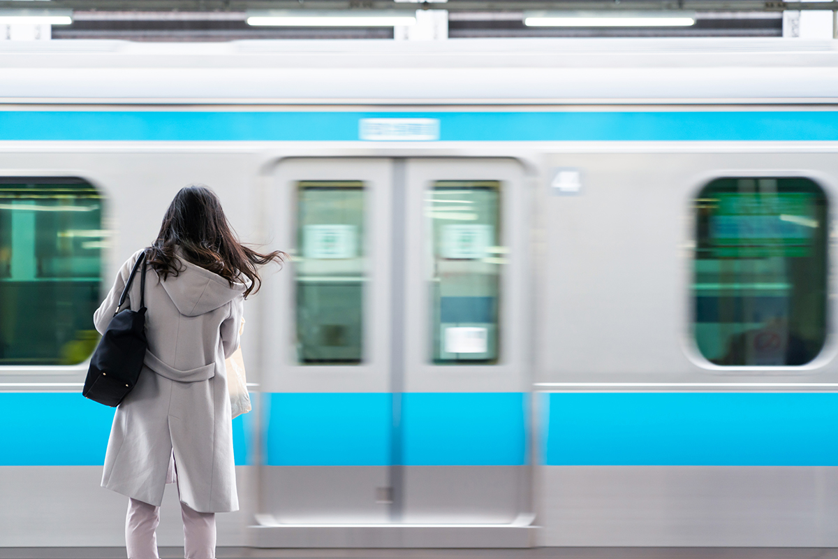 business woman with blur of Tokyo trains