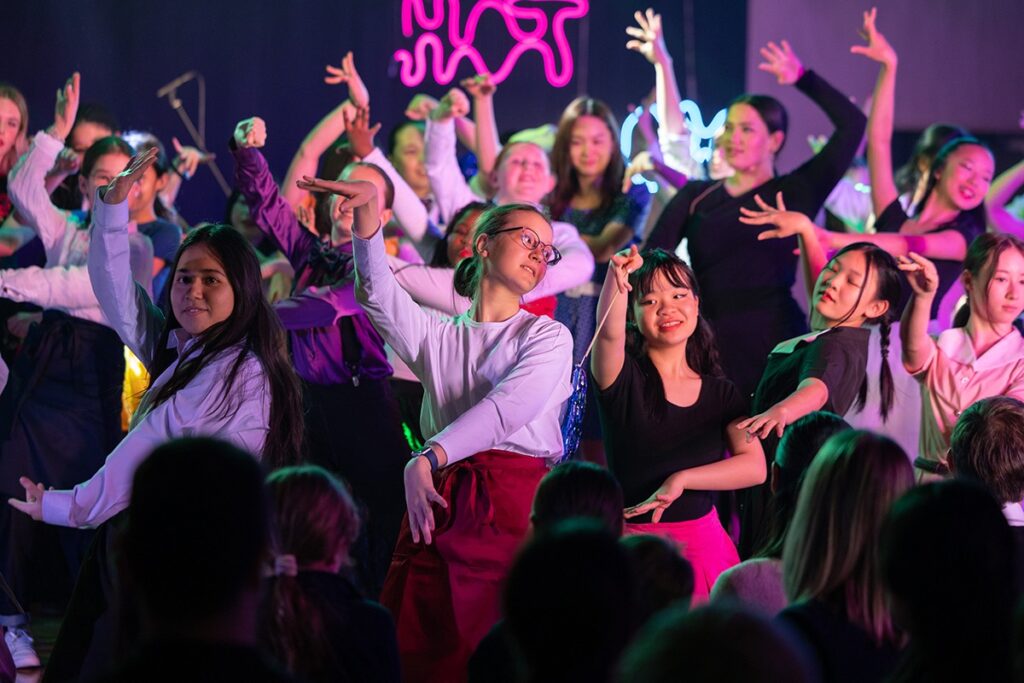 Students participating in music, sports and arts activities at The British School in Tokyo as part of a holistic education program.