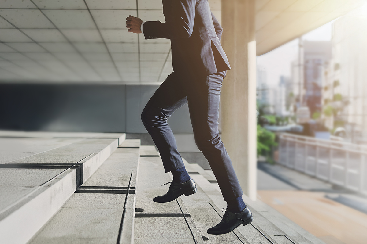 Man walking up steps developing survival strength