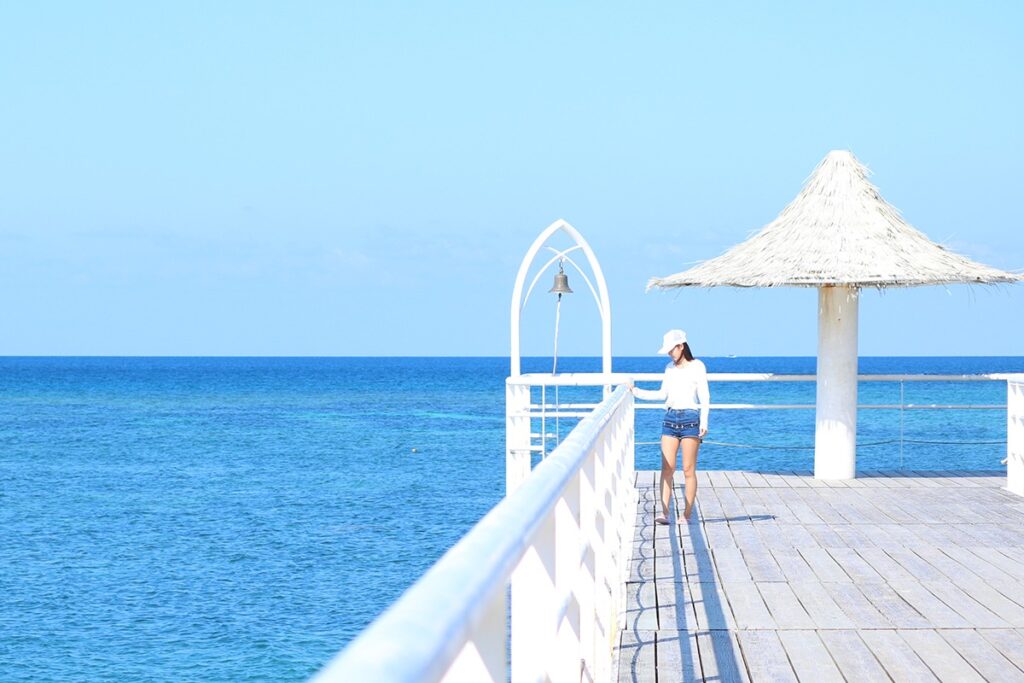 woman on a deck in front of the Okinawa ocean