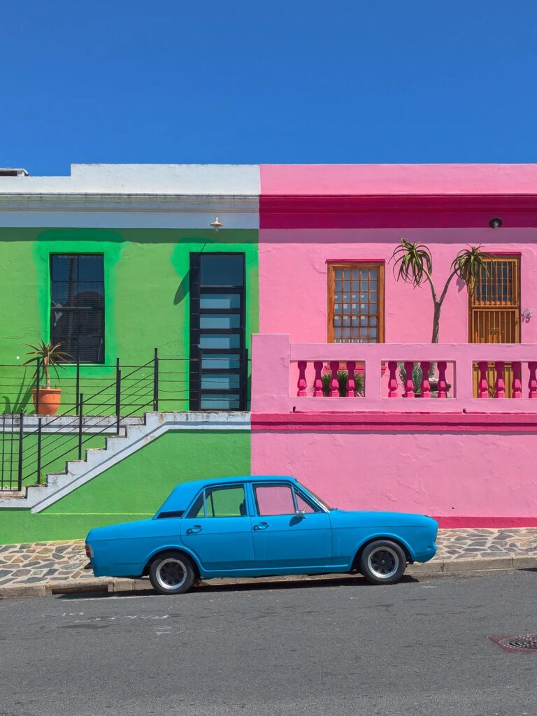 colorful houses with a blue car in front