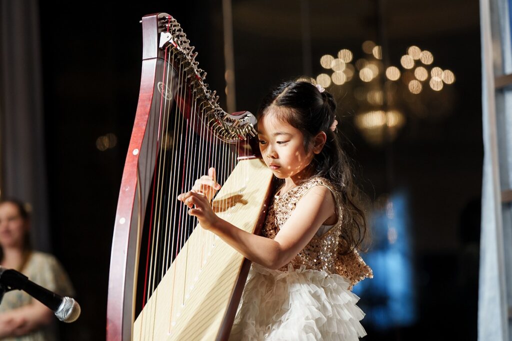 young girl playing the harp