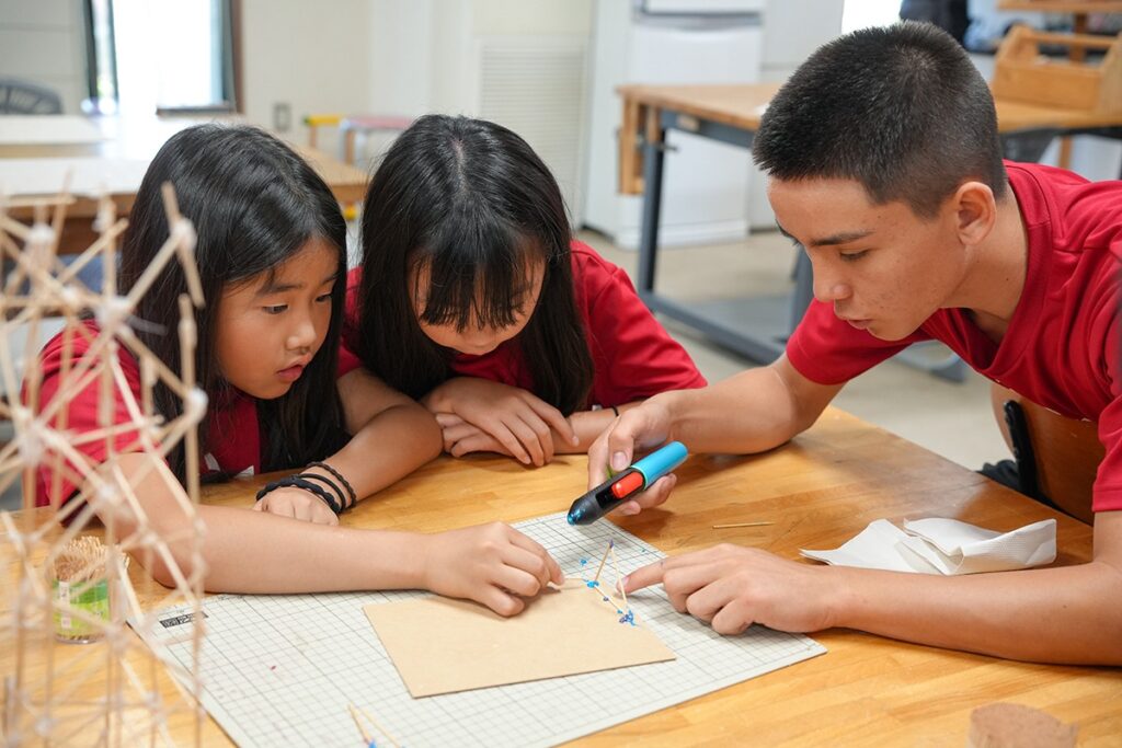 Canadian Academy students constructing a project in a team activity