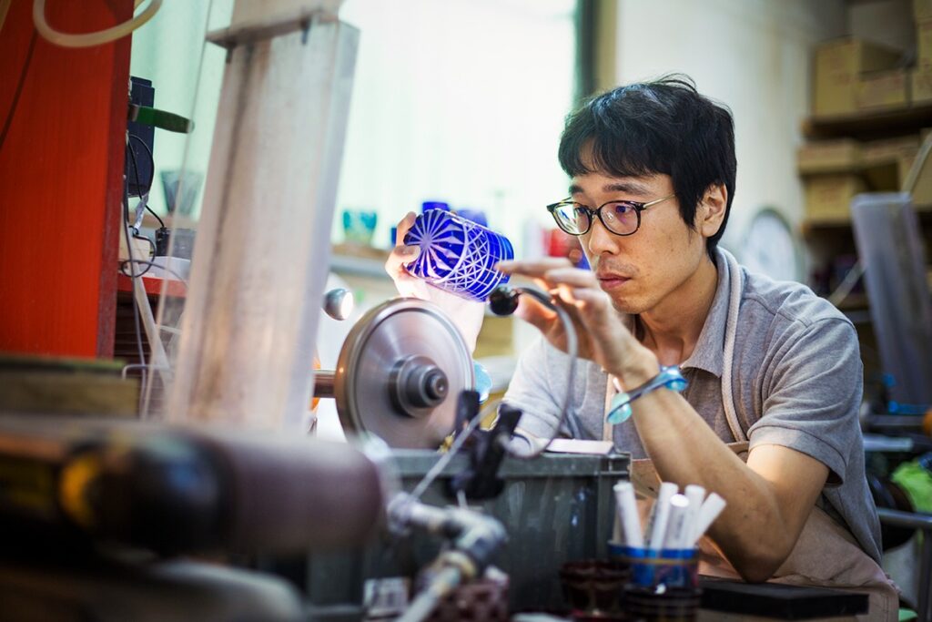 Japanese artisan crafting a glass