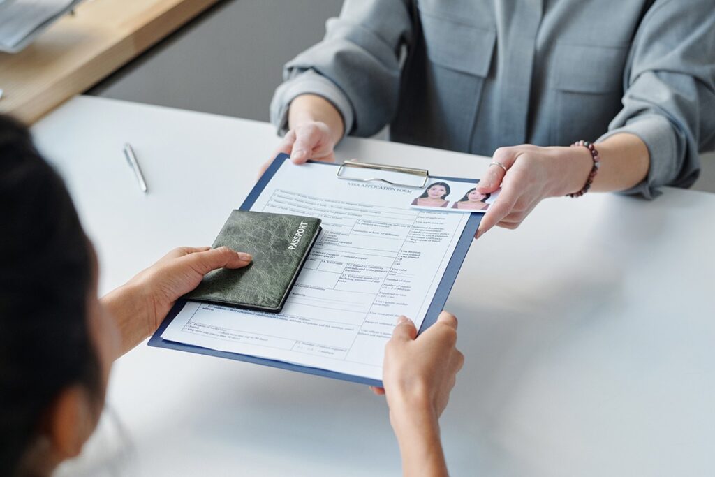 Applicant passing Visa documents to government worker