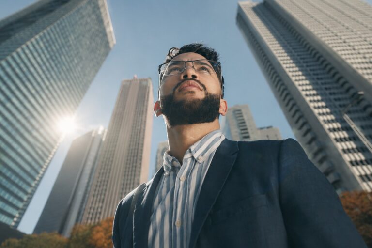 A man looking at buildings in Shinjuku, Tokyo with aspirations to work in Japan