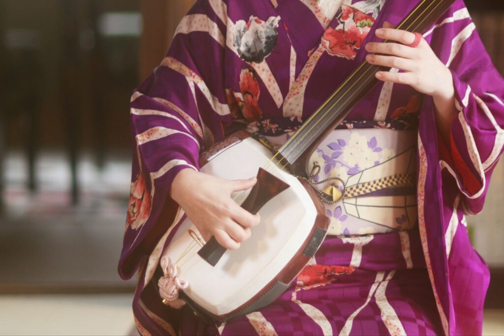 Lady in a Kimono playing a shamisen
