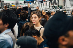 Woman obeying Tokyo train etiquette in Tokyo