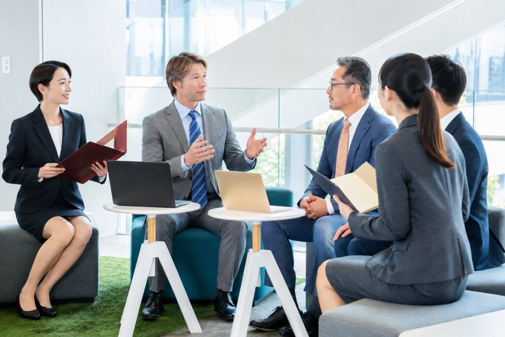 confident foreign businessman in a meeting with Japanese business people
