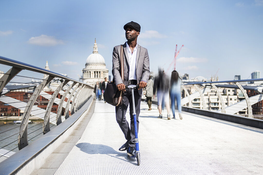 Businessman on scooter, Millennium Bridge, London, UK