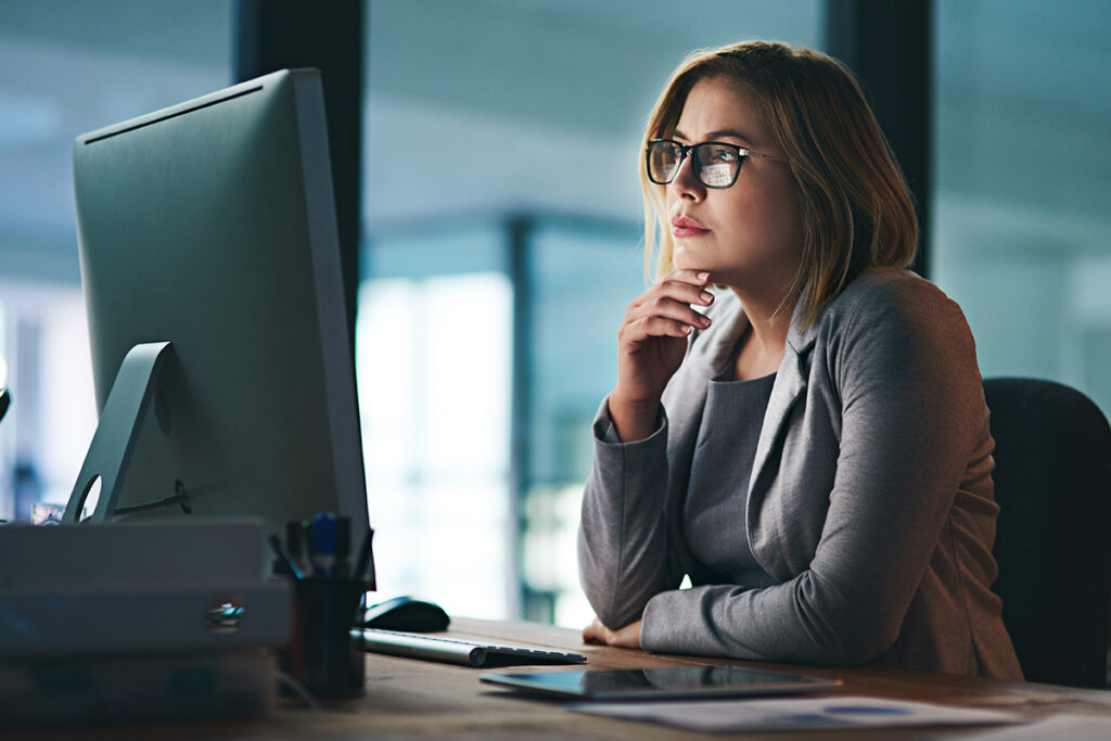 Young businesswoman working late on a computer in an office
